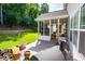 Well maintained backyard features a cozy screened-in porch, a lush lawn, and a privacy fence with mature trees at 613 Hemlock Ct, Villa Rica, GA 30180
