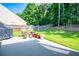 Relaxing backyard patio with lush green grass, privacy fence, and outdoor grill, ideal for Gathering gatherings at 613 Hemlock Ct, Villa Rica, GA 30180