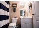 Bathroom with striped shower curtain, white vanity, and wood decorations at 613 Hemlock Ct, Villa Rica, GA 30180