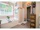 Bathroom featuring bathtub with a large window and tile flooring at 613 Hemlock Ct, Villa Rica, GA 30180