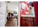 Bathroom featuring wood cabinets, red walls, and decorative lamps at 613 Hemlock Ct, Villa Rica, GA 30180