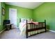 Bedroom featuring light green walls and a traditional bed frame at 613 Hemlock Ct, Villa Rica, GA 30180