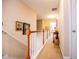 Hallway with staircase, neutral walls, and wood banister at 613 Hemlock Ct, Villa Rica, GA 30180