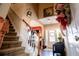 Staircase with views of the front door, red accent wall, and hardwood floors at 613 Hemlock Ct, Villa Rica, GA 30180