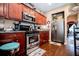 Well-lit kitchen with stainless steel appliances, granite countertops, and dark wood cabinets at 613 Hemlock Ct, Villa Rica, GA 30180