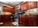 Well-equipped kitchen boasting dark wood cabinets, granite countertops, and stainless steel appliances at 613 Hemlock Ct, Villa Rica, GA 30180