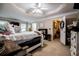 Main bedroom featuring a decorative tray ceiling with fan at 613 Hemlock Ct, Villa Rica, GA 30180