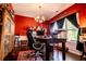 Bright home office with a wooden desk, chandelier, and ample natural light at 613 Hemlock Ct, Villa Rica, GA 30180