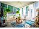Comfortable screened porch features ceiling fan, bright natural light, and a cozy seating area with tasteful decorations at 613 Hemlock Ct, Villa Rica, GA 30180