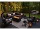 View of an outdoor living space with deck, comfortable seating, a fire pit, and string lights at 5531 Four Winds Sw Dr, Lilburn, GA 30047