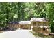 Two-story home featuring a spacious multi-car garage, surrounded by lush greenery and mature trees at 5531 Four Winds Sw Dr, Lilburn, GA 30047
