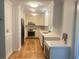 Modern kitchen with sleek stainless steel appliances, white cabinets and drawers, beautiful backsplash and hardwood floors at 5531 Four Winds Sw Dr, Lilburn, GA 30047