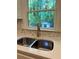 Kitchen sink features modern faucet, mosaic tile backsplash, and window with green outdoor view at 5531 Four Winds Sw Dr, Lilburn, GA 30047