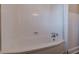 Close-up on a pristine white bathtub and tiled wall in the bathroom at 1376 Westmont Sw Rd, Atlanta, GA 30311