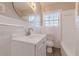 Bright bathroom featuring a white vanity, round mirror, and combined tub and shower at 1376 Westmont Sw Rd, Atlanta, GA 30311