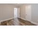 This bedroom offers wood-look flooring, neutral walls, and doorway to another room at 1376 Westmont Sw Rd, Atlanta, GA 30311