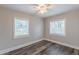 This bedroom has hardwood floors, neutral paint, and two windows that let in plenty of natural light at 1376 Westmont Sw Rd, Atlanta, GA 30311