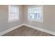 A bright bedroom with two windows and wood-look floors, offering a serene and inviting space at 1376 Westmont Sw Rd, Atlanta, GA 30311
