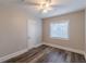 Bright bedroom with neutral paint, modern ceiling fan, and stylish wood-look floors at 1376 Westmont Sw Rd, Atlanta, GA 30311