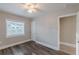 This bedroom features hardwood floors, a ceiling fan, neutral paint, and a window for natural light at 1376 Westmont Sw Rd, Atlanta, GA 30311
