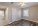 This bedroom features hardwood floors, a ceiling fan, neutral paint, and a window for natural light at 1376 Westmont Sw Rd, Atlanta, GA 30311