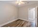 Bedroom with neutral walls, wood-look floors, ceiling fan and doorway to adjoining room at 1376 Westmont Sw Rd, Atlanta, GA 30311