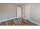 This bedroom has wood-look flooring, neutral walls, and two doors for convenience at 1376 Westmont Sw Rd, Atlanta, GA 30311