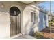 Close up of front door with arched frame, window and a covered porch with updated siding and trim at 1376 Westmont Sw Rd, Atlanta, GA 30311