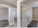 Hallway featuring neutral paint and multiple doorways leading to various rooms with hard surface flooring at 1376 Westmont Sw Rd, Atlanta, GA 30311