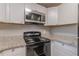 A kitchen equipped with stainless steel appliances and granite counters, perfect for culinary enthusiasts at 1376 Westmont Sw Rd, Atlanta, GA 30311