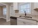 A well-lit kitchen with granite counters and a stainless steel dishwasher, providing a modern and functional space at 1376 Westmont Sw Rd, Atlanta, GA 30311