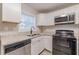 A bright kitchen featuring granite counters and modern appliances, providing a fresh and inviting cooking environment at 1376 Westmont Sw Rd, Atlanta, GA 30311