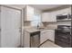 A kitchen with stainless steel appliances, granite counters, and bright cabinetry, offering a stylish and functional space at 1376 Westmont Sw Rd, Atlanta, GA 30311