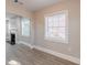 A sunlit living room featuring an archway, fireplace, and large windows, creating a cozy atmosphere at 1376 Westmont Sw Rd, Atlanta, GA 30311