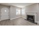 Open-concept living room with fireplace, updated flooring, fresh paint, and an arched front door at 1376 Westmont Sw Rd, Atlanta, GA 30311