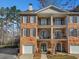 Brick townhome featuring a private entry, a garage, and private outdoor balconies on multiple levels at 2599 Oglethorpe Ne Cir, Brookhaven, GA 30319