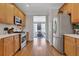 Galley-style kitchen featuring stainless steel appliances, wood cabinets, and hardwood floors at 2599 Oglethorpe Ne Cir, Brookhaven, GA 30319