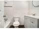 Bathroom featuring tile walls, a new vanity, and a toilet and tub combo at 3080 Forrest Park Road Se, Atlanta, GA 30354