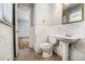 A bathroom featuring marble walls, a pedestal sink, and new toilet at 3080 Forrest Park Road Se, Atlanta, GA 30354