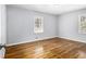 Bedroom with hardwood floors, natural light from the windows, and neutral paint throughout at 3080 Forrest Park Road Se, Atlanta, GA 30354