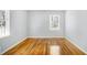Bedroom with hardwood floors, base trim, neutral paint, and natural light from the window at 3080 Forrest Park Road Se, Atlanta, GA 30354
