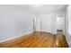 Bedroom featuring hardwood floors, neutral paint, and access to an ensuite bathroom at 3080 Forrest Park Road Se, Atlanta, GA 30354