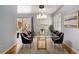 Bright dining room featuring a glass-top table, elegant lighting, and neutral décor at 3080 Forrest Park Road Se, Atlanta, GA 30354