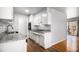 A modern kitchen with white cabinetry, granite countertops, and stainless steel appliances at 3080 Forrest Park Road Se, Atlanta, GA 30354