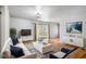 Bright living room featuring hardwood floors, modern furniture, and a sliding door to the outside at 3080 Forrest Park Road Se, Atlanta, GA 30354