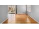 Sunlit room with hardwood floors, access to a balcony, and a large window at 3080 Forrest Park Road Se, Atlanta, GA 30354