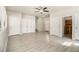 Open living room with wood-look tile, ceiling fan, and multiple closets for ample storage space at 3080 Forrest Park Road Se, Atlanta, GA 30354