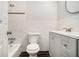 Bright bathroom includes a tiled shower-tub combo, a modern vanity and updated toilet at 3080 Forrest Park Se Rd, Atlanta, GA 30354