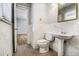 Bathroom featuring a toilet and pedestal sink next to an open doorway to another room at 3080 Forrest Park Se Rd, Atlanta, GA 30354
