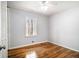 Cozy bedroom featuring neutral walls, hardwood flooring, a closet, and bright natural light at 3080 Forrest Park Se Rd, Atlanta, GA 30354
